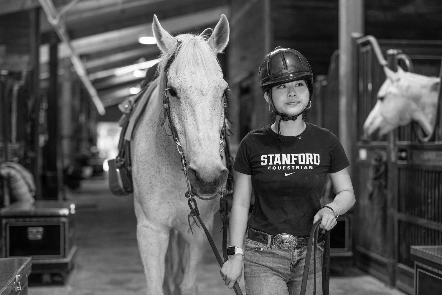 Image of Angeline leading her horse out of the stable.