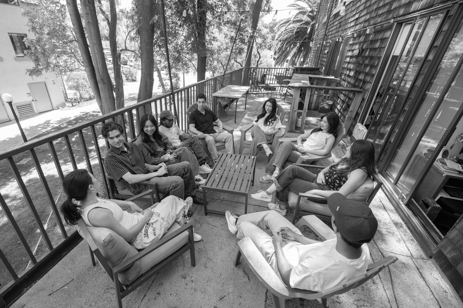 Image of Angeline hanging out with her friends outside on a balcony patio.
