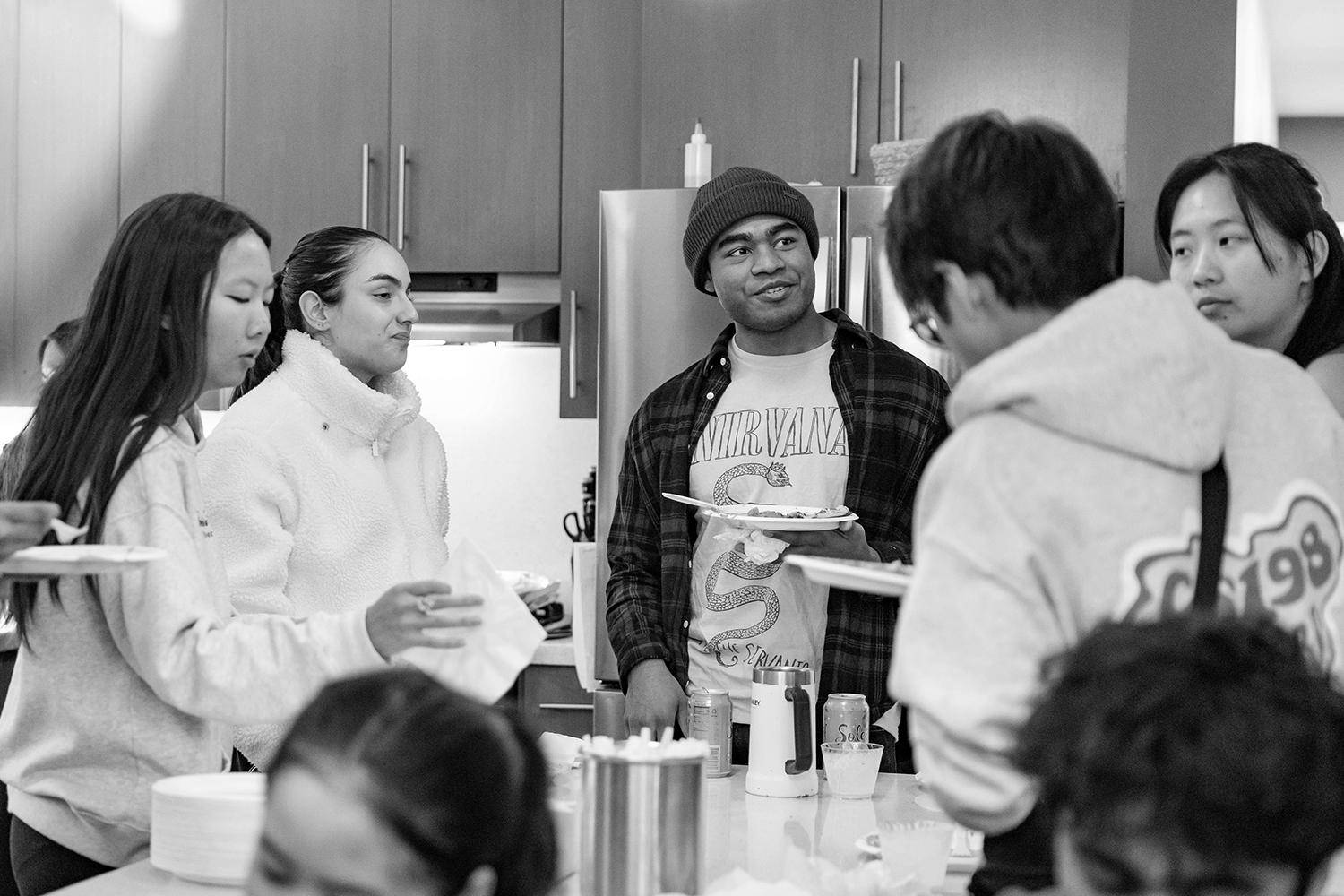Students gather in a dorm dinning area to enjoy snacks during a Civic Salon discussion.
