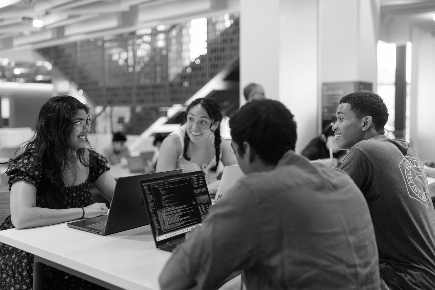 Image of Diego studying at a table with his friends in the new CoDa building.