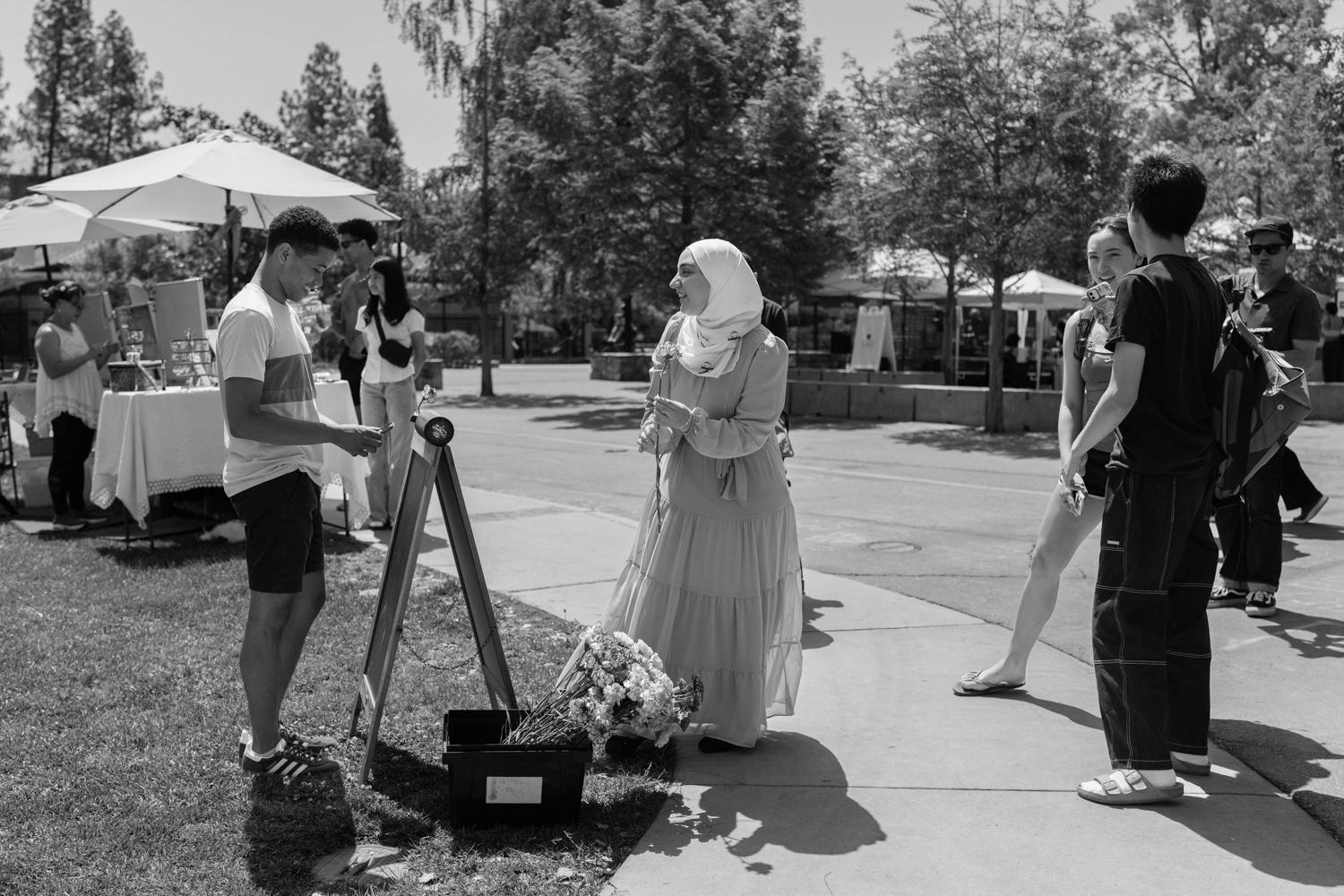 Image of Diego handing out free flowers on the Stanford campus.