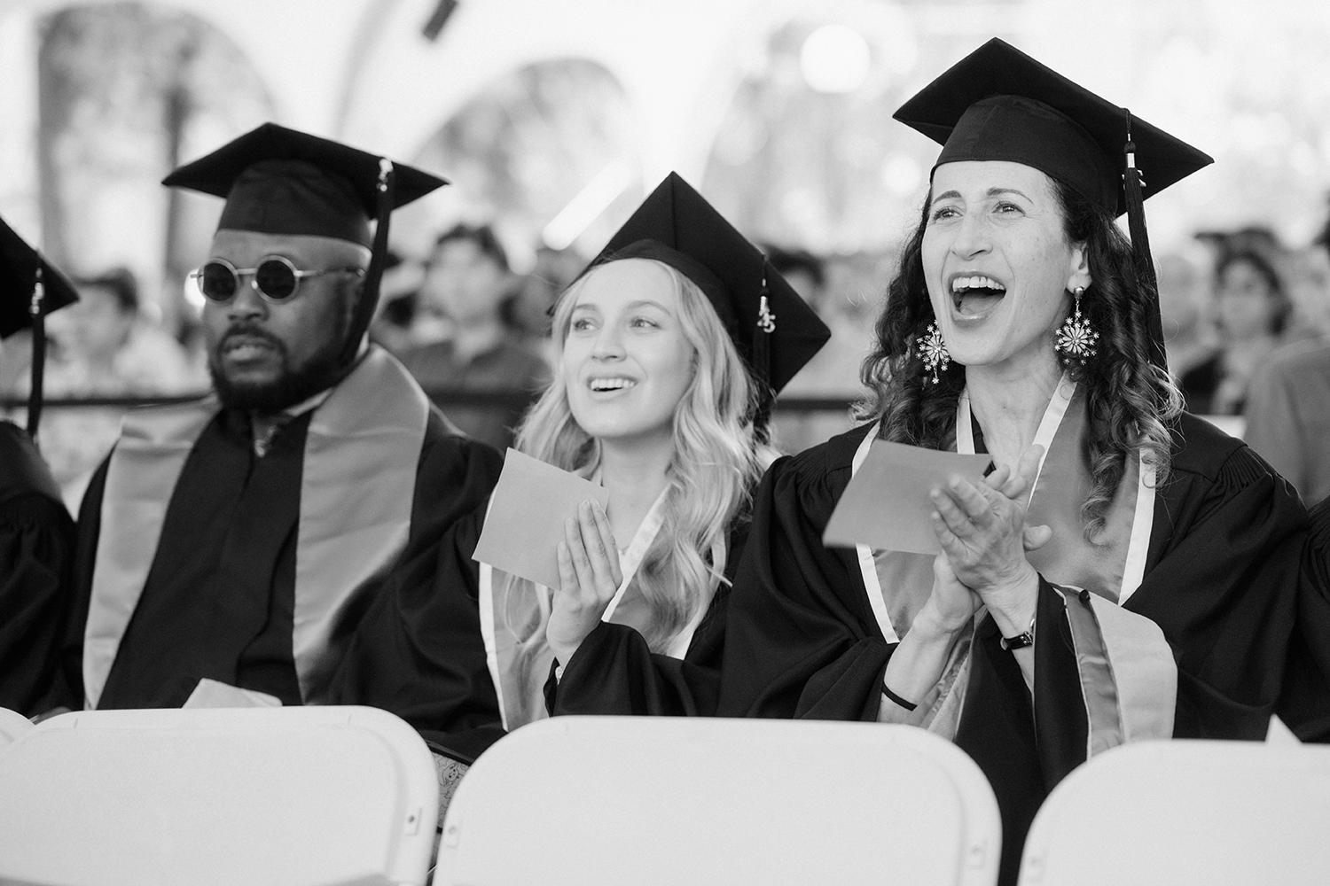 Image of graduating students cheering for one another.