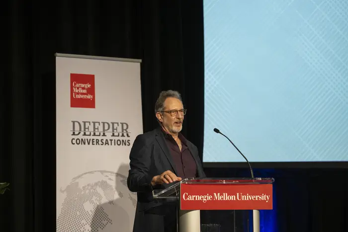 Dean Richard Scheines at a podium.