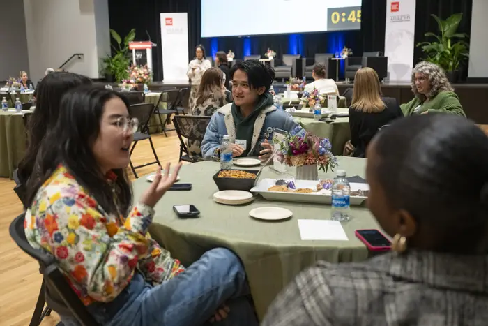 People talk sitting around tables.