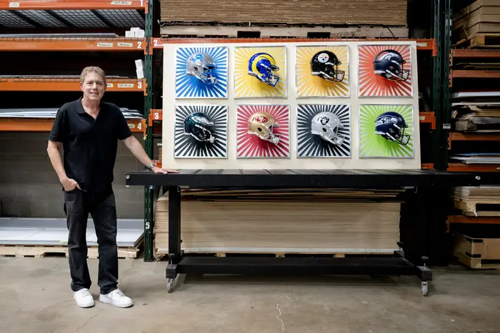 Burton Morris in front of his NFL draft art.