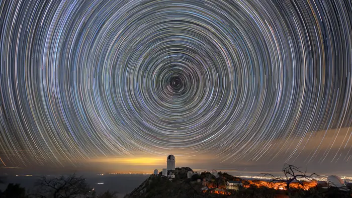 Star trails over the Mayall Telescope that houses DESI. Credit: Luke Tyas/Berkeley Lab and KPNO/NOIRLab/NSF/AURA